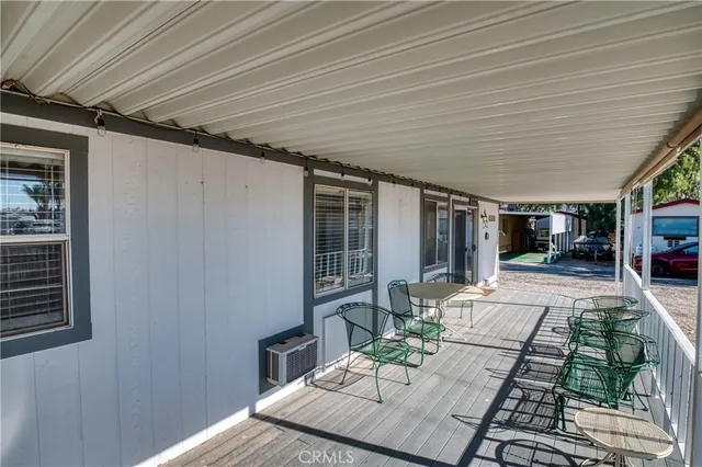 a kitchen with granite countertop a table chairs a sink and stainless steel appliances