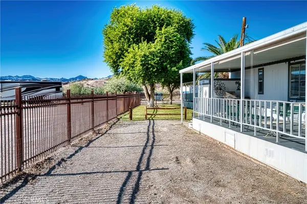 a view of yard with swimming pool and lake view