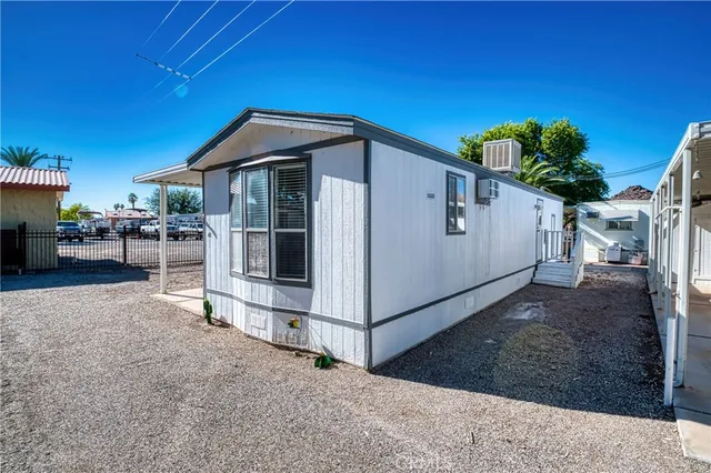 a white house that has a tree in front of it