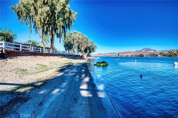 an aerial view of residential houses with outdoor space and river