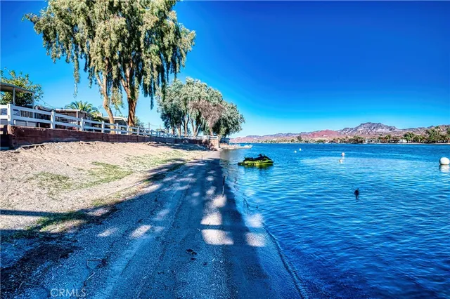 an aerial view of residential houses with outdoor space and river