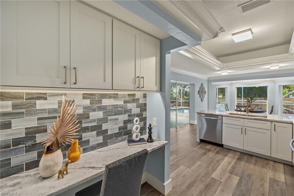 2796 Clipper Way Naples, FL 34104 - Photo 14 of 36 OFFICE / STUDY / WIFI box area counters, stainless steel dishwasher, light wood-type flooring, and ornamental molding