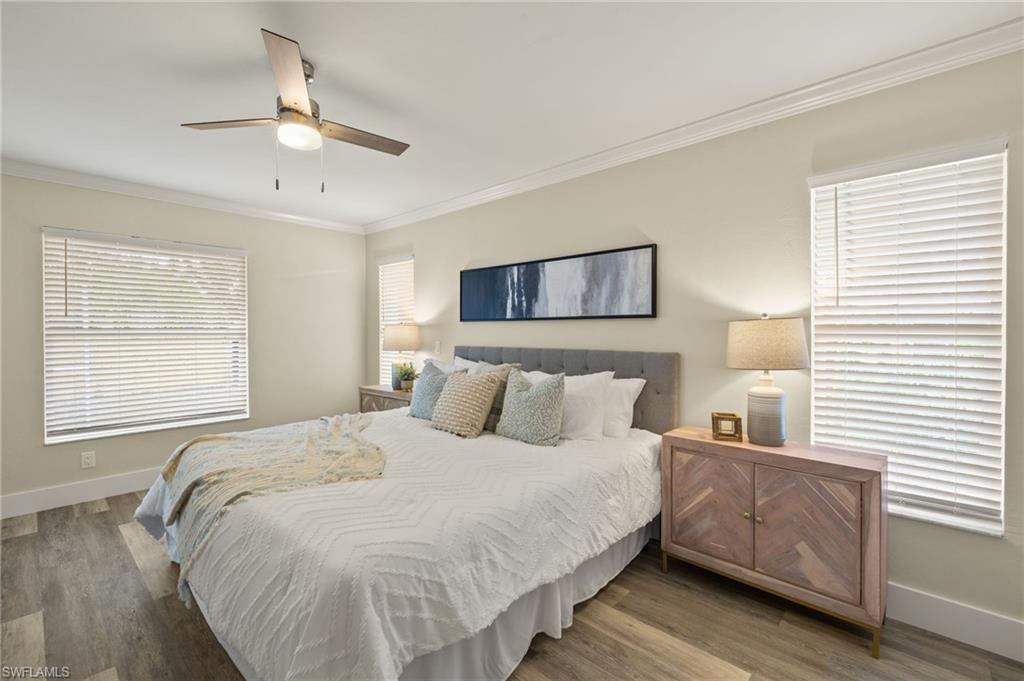 2796 Clipper Way Naples, FL 34104 - Photo 17 of 36 master Bedroom featuring multiple windows, hardwood / wood-style floors, and ceiling fan