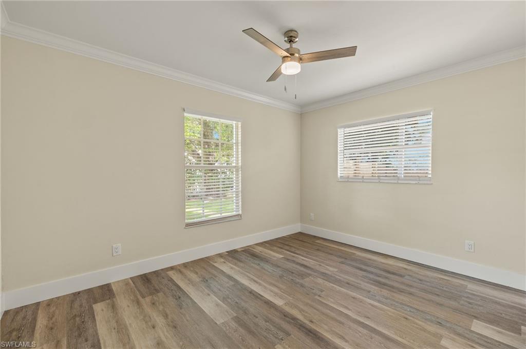 2796 Clipper Way Naples, FL 34104 - Photo 20 of 36 Unfurnished room featuring crown molding, ceiling fan, and light hardwood / wood-style floors
