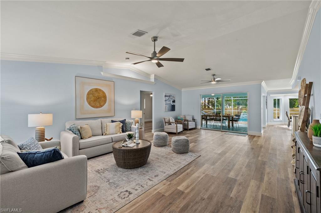 2796 Clipper Way Naples, FL 34104 - Photo 4 of 36 Living room featuring ornamental molding, light hardwood / wood-style floors, ceiling fan, and lofted ceiling