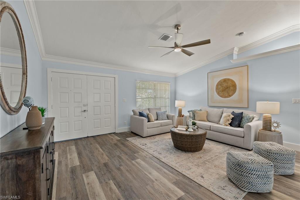 2796 Clipper Way Naples, FL 34104 - Photo 6 of 36 Living room featuring ceiling fan, wood-type flooring, crown molding, and lofted ceiling