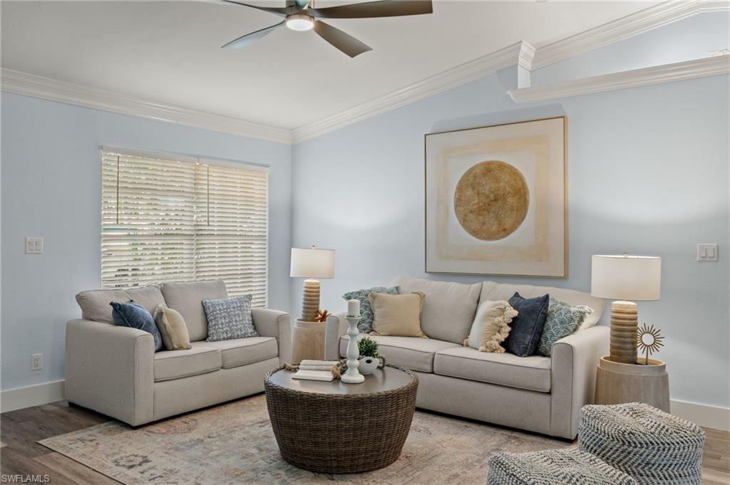 2796 Clipper Way Naples, FL 34104 - Photo 7 of 36 Living room featuring crown molding, vaulted ceiling, and hardwood / wood-style flooring