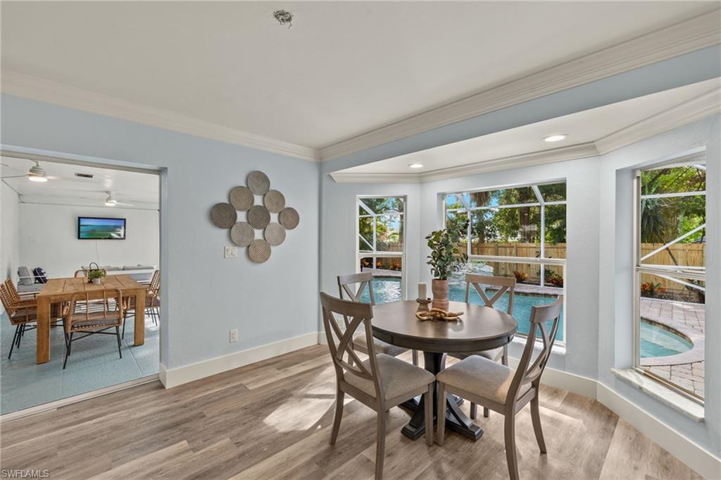 2796 Clipper Way Naples, FL 34104 - Photo 10 of 36 Dining room with light hardwood / wood-style flooring, a wealth of natural light, crown molding, and ceiling fan