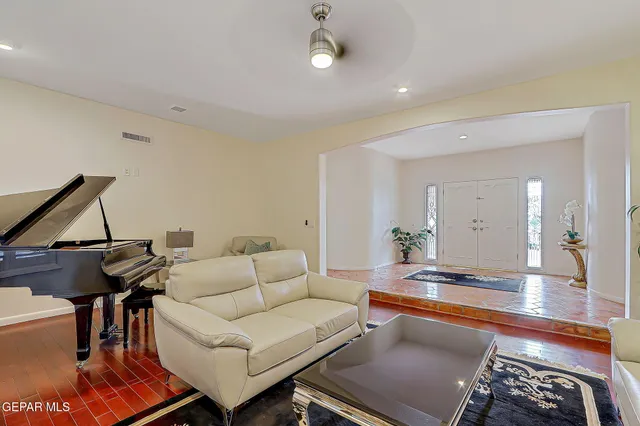 a living room with furniture a chandelier and a window