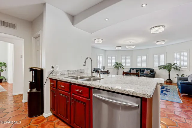 a kitchen with stainless steel appliances granite countertop a refrigerator and a sink
