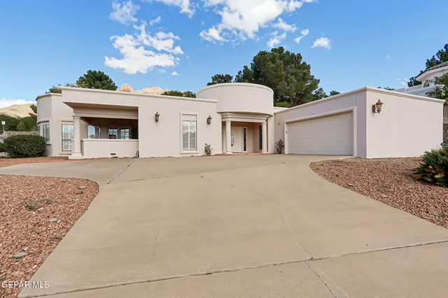 a view of white house with a yard and garage