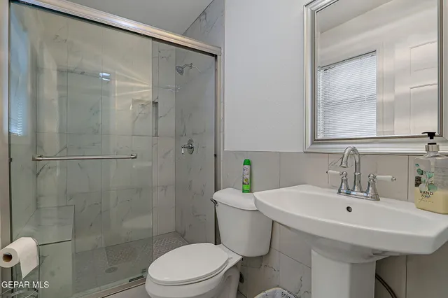 a bathroom with a toilet sink and shower