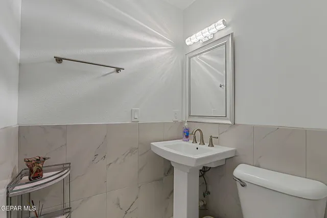 a living room with furniture a couch and a flat screen tv