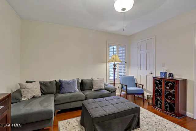 a living room with furniture and a wooden floor