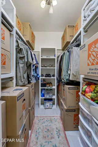 a bathroom with a granite countertop double vanity sink and a mirror