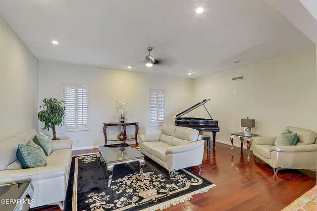 a living room with furniture and a potted plant