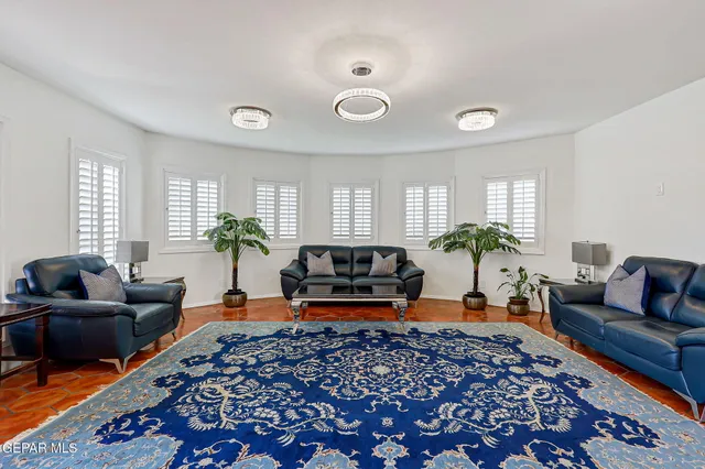 a living room with furniture and a dining table