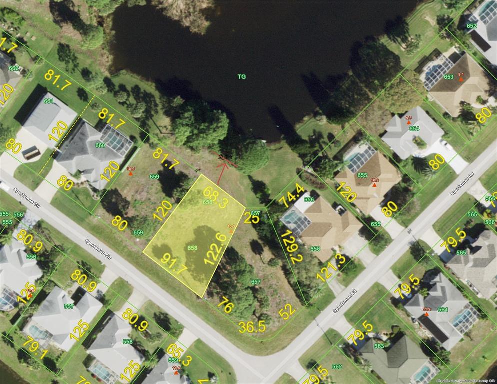 an aerial view of a residential houses with yard