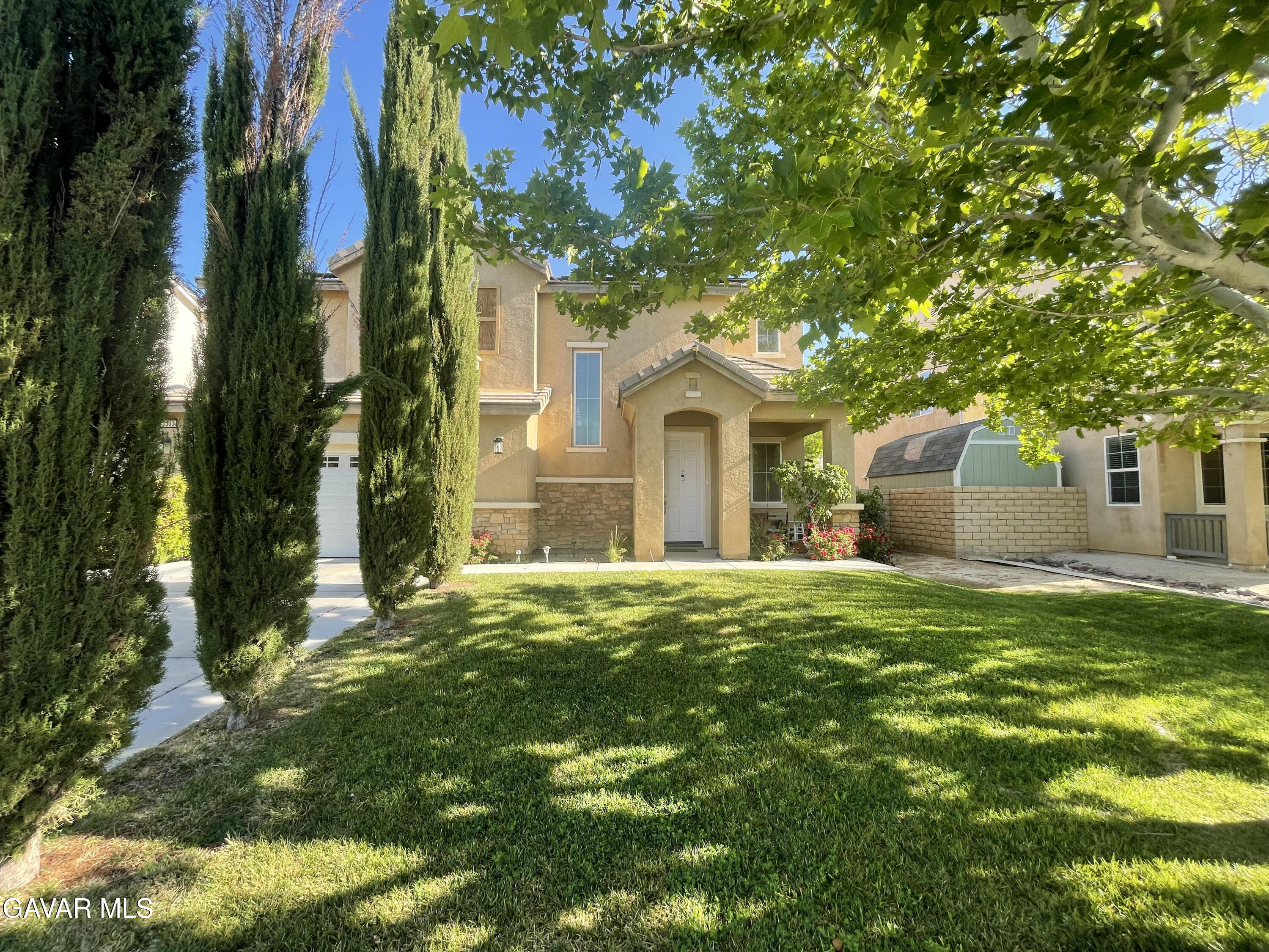 3303 Arious Way Lancaster, CA 93536 - Photo 1 of 43 a front view of a house with a garden