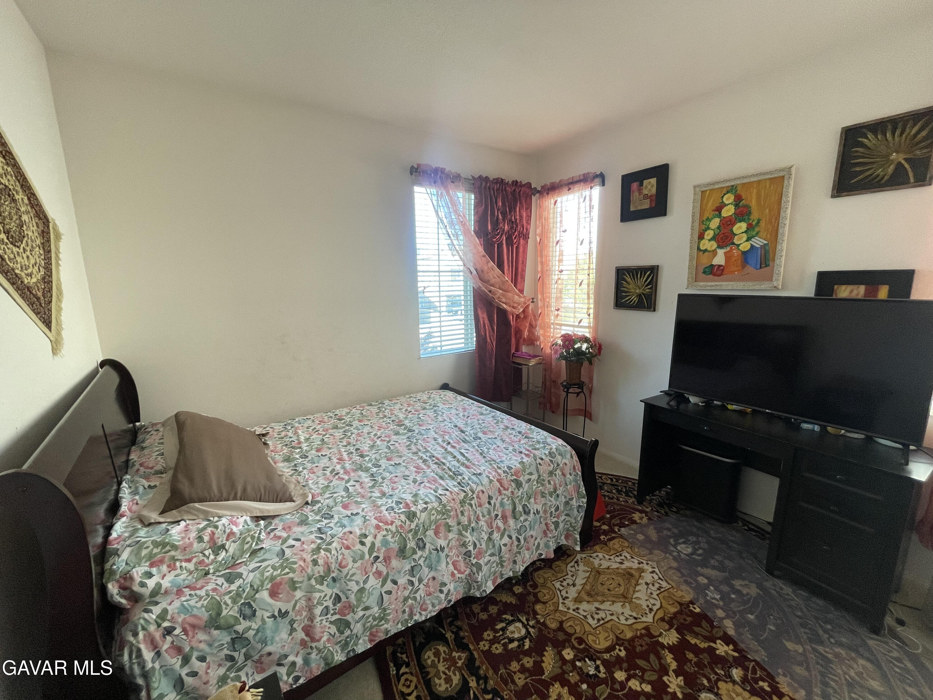 3303 Arious Way Lancaster, CA 93536 - Photo 34 of 43 a bedroom with a bed and a flat screen tv