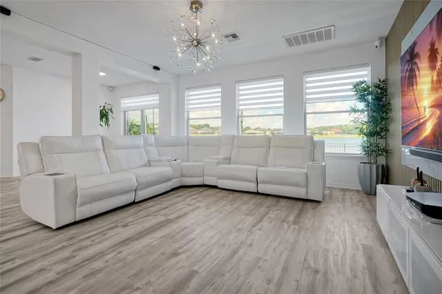 a kitchen with stainless steel appliances granite countertop a sink a stove a refrigerator and a oven with wooden floor