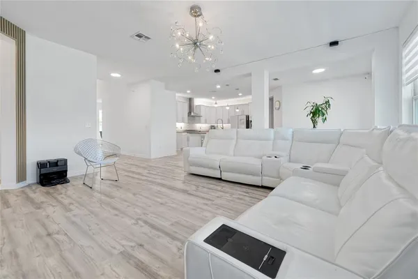 a kitchen with granite countertop white cabinets and a sink