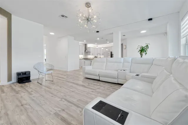 a kitchen with granite countertop white cabinets and a sink