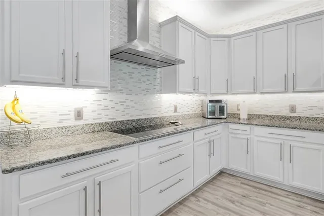 a dining room with furniture and a kitchen