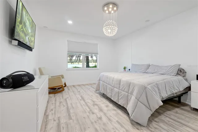 a large white kitchen with a sink and dishwasher with white cabinets