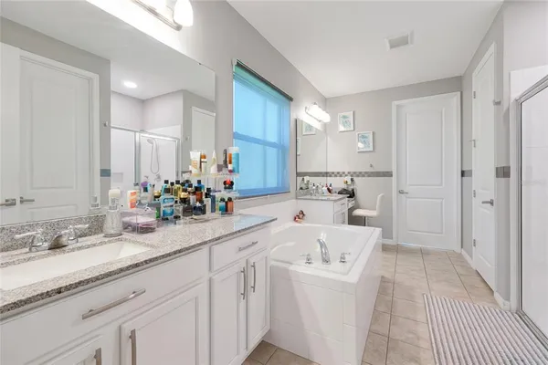 a bathroom with a sink mirror and toilet