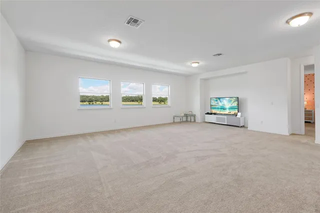 a bed sitting in a room next to a lamp