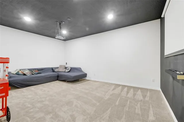 an aerial view of a house with a swimming pool lake and mountain view