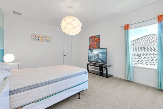 an aerial view of a house with swimming pool garden and lake view