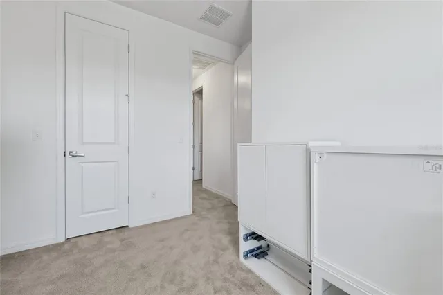 an aerial view of residential houses with outdoor space and lake view