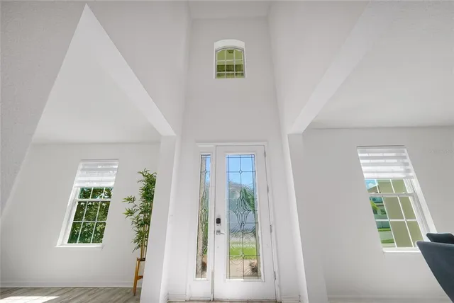 a view of an entryway with wooden floor