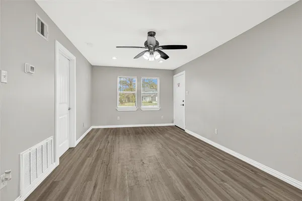 wooden floor in an empty room with a window