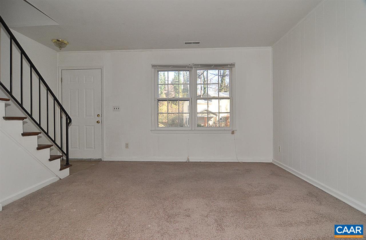 319 Valley Rd Extension, Unit 319 Charlottesville, VA 22903 - Photo 5 of 15 an empty room with wooden floor and windows