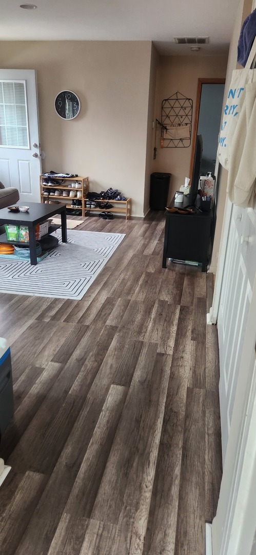 1770 Queensbury Circle Hoffman Estates, IL 60169 - Photo 7 of 14 a living room with furniture and a fireplace