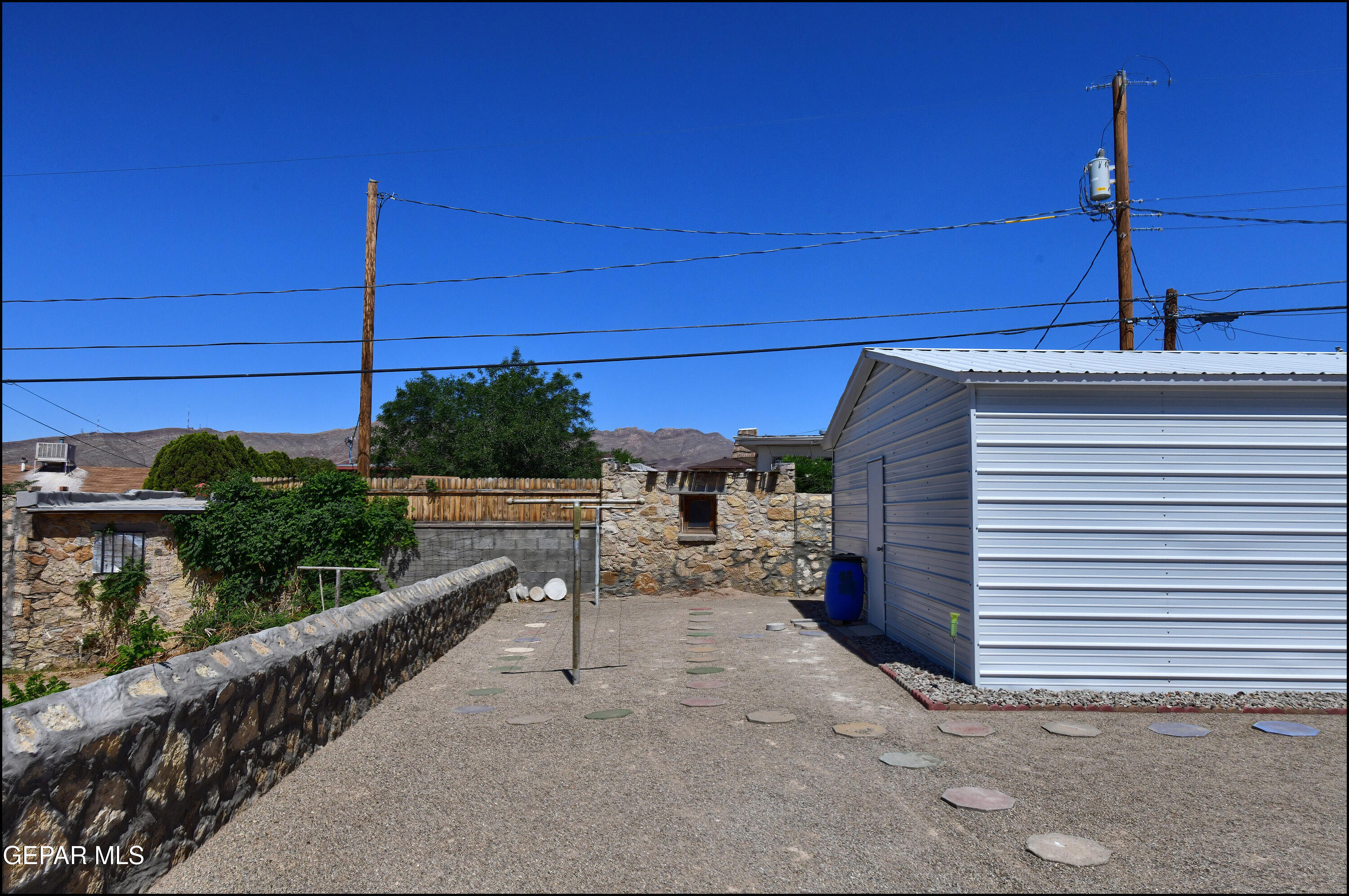 5107 Raymond Jays Road El Paso, TX 79903 - Photo 34 of 35 a view of a patio with table and chairs with wooden fence