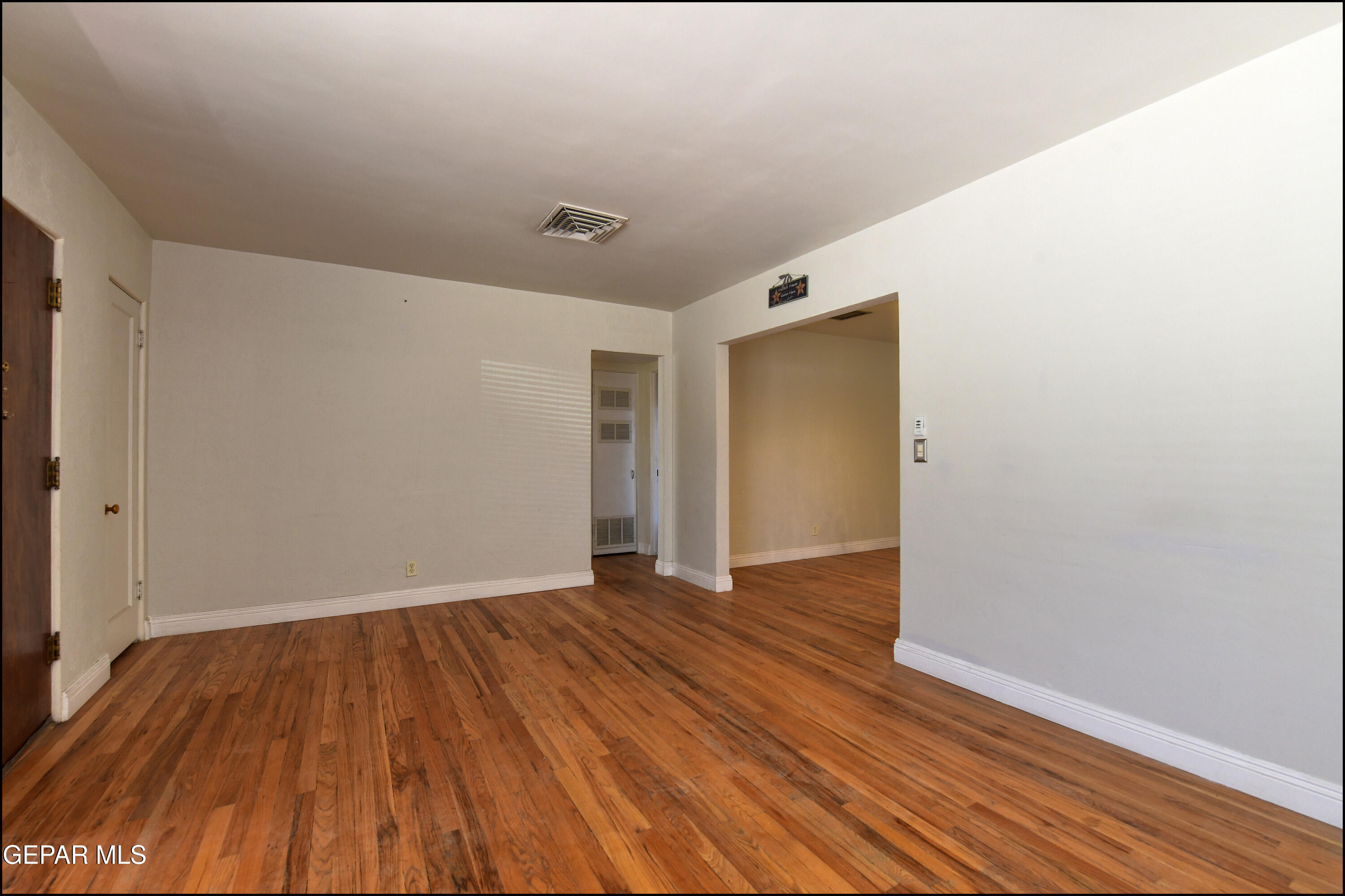 5107 Raymond Jays Road El Paso, TX 79903 - Photo 5 of 35 a view of an empty room with wooden floor