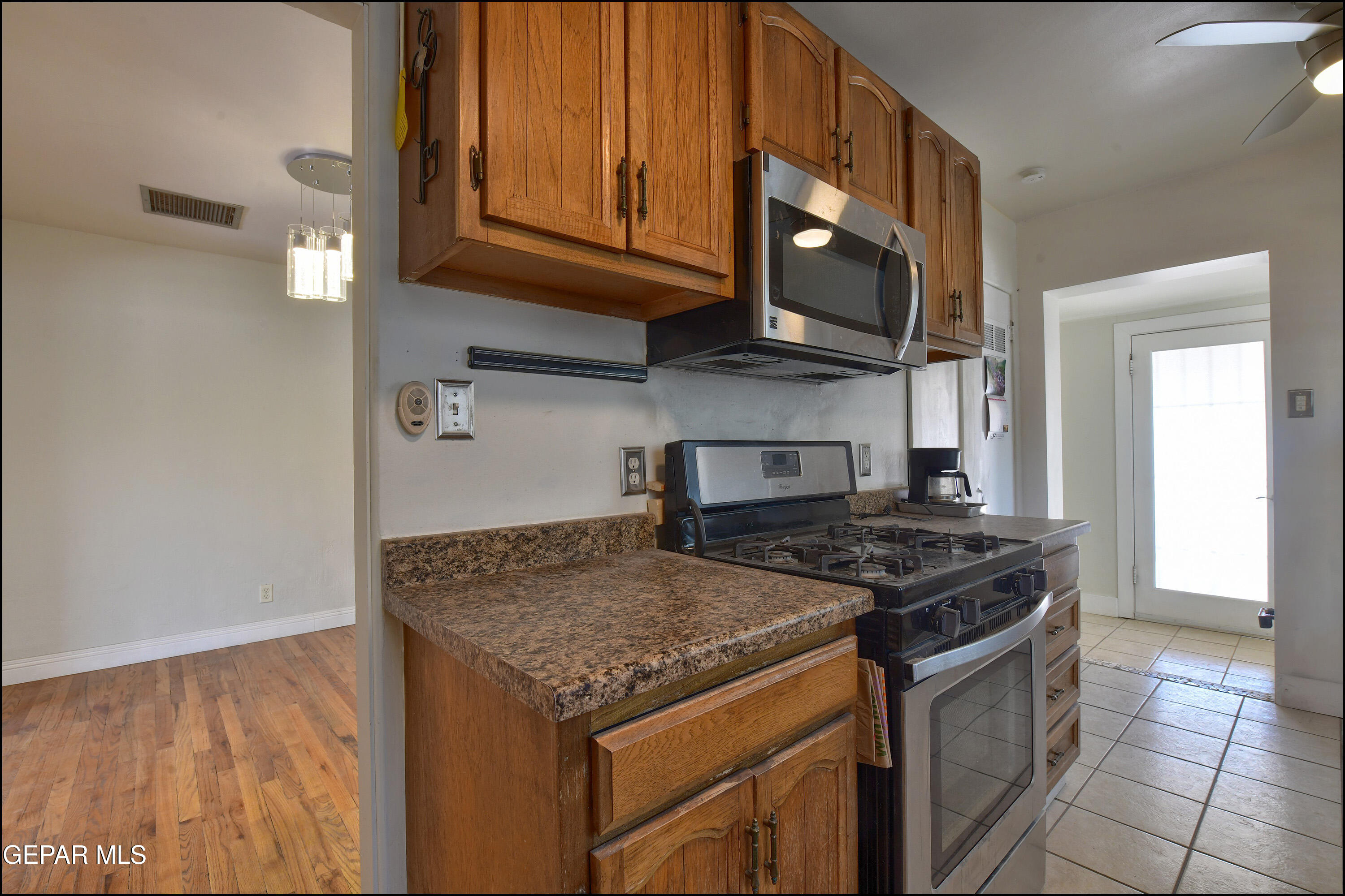 5107 Raymond Jays Road El Paso, TX 79903 - Photo 8 of 35 a kitchen with stainless steel appliances granite countertop a stove and a microwave