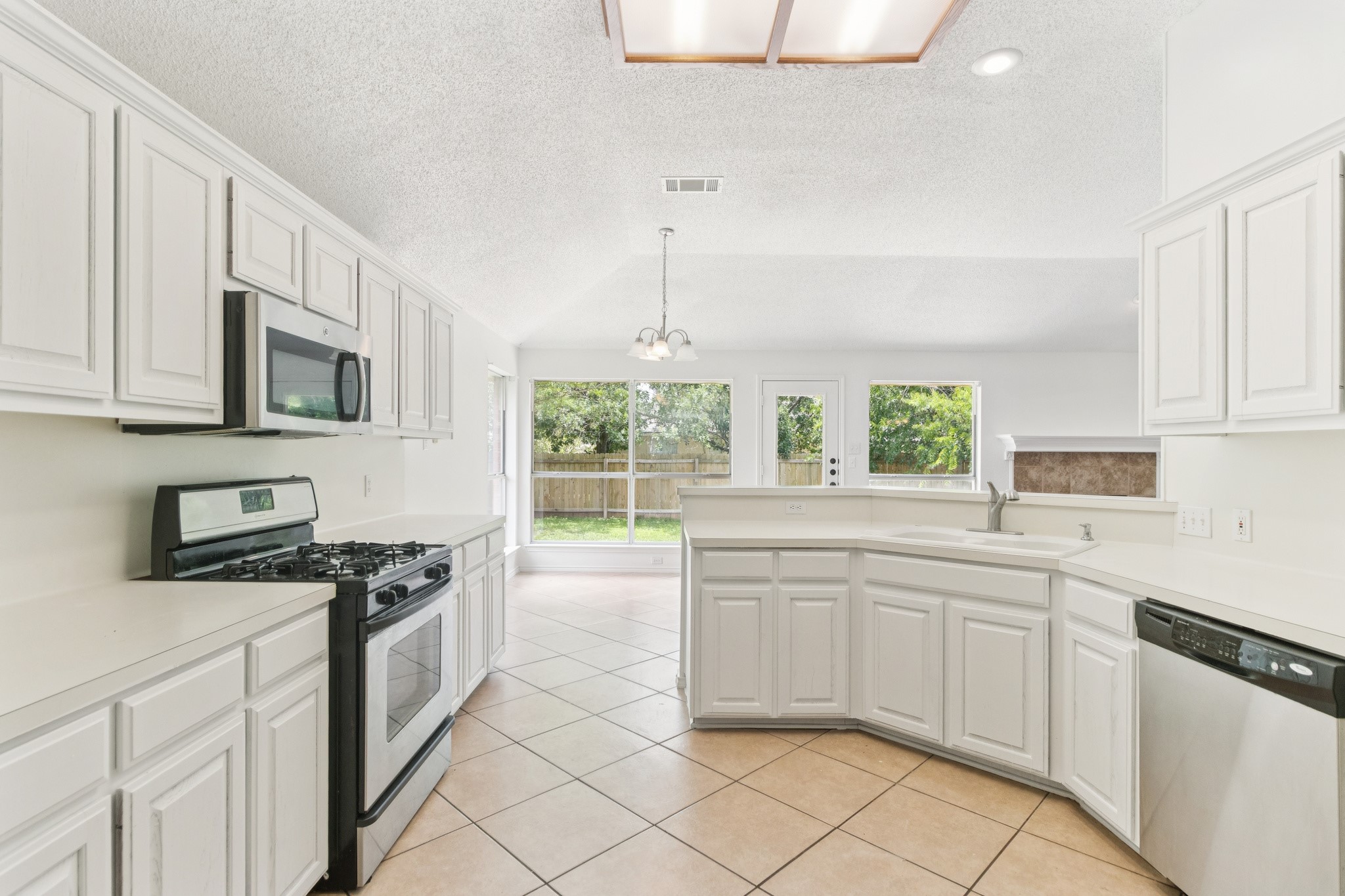 800 Mountain Ridge Drive Leander, TX 78641 - Photo 9 of 31 Tiled flooring and matching cabinetry define this functional kitchen layout.