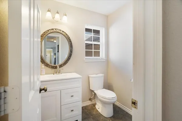 a bathroom with a toilet a sink and a mirror