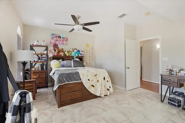 a bedroom with furniture and a fan