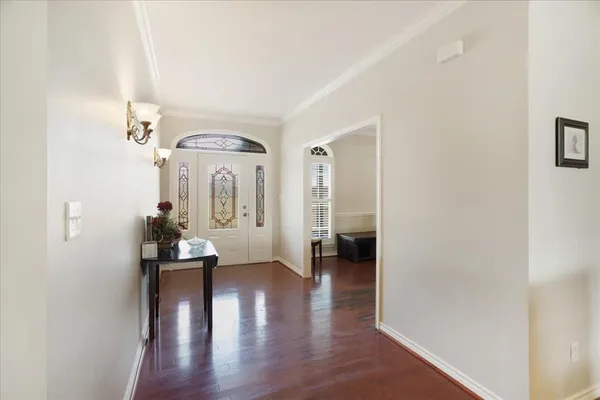 a view of a hallway with wooden floor