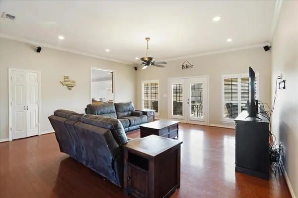 a living room with furniture and a chandelier