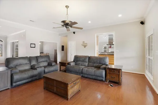 a living room with furniture and a wooden floor