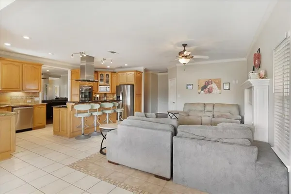 a living room with couches and kitchen view