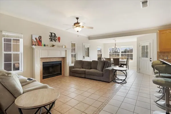 a living room with furniture a fireplace and a flat screen tv