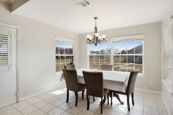 a view of a dining room with furniture wooden floor and chandelier